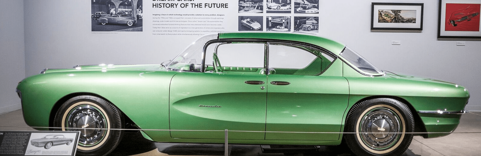 A classic green car parked in the showroom with details