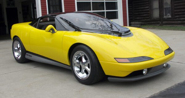 Yellow sports car parked in driveway.