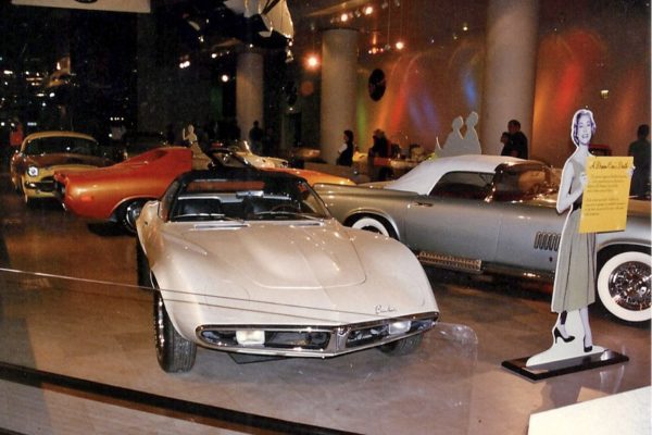 White sports car on display in showroom.